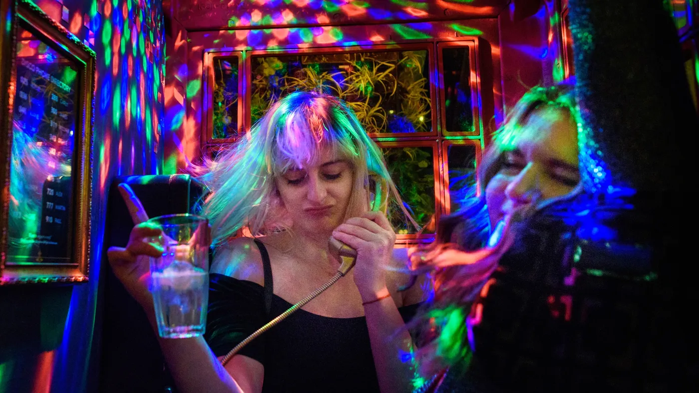Two people dancing in a disco phonebox