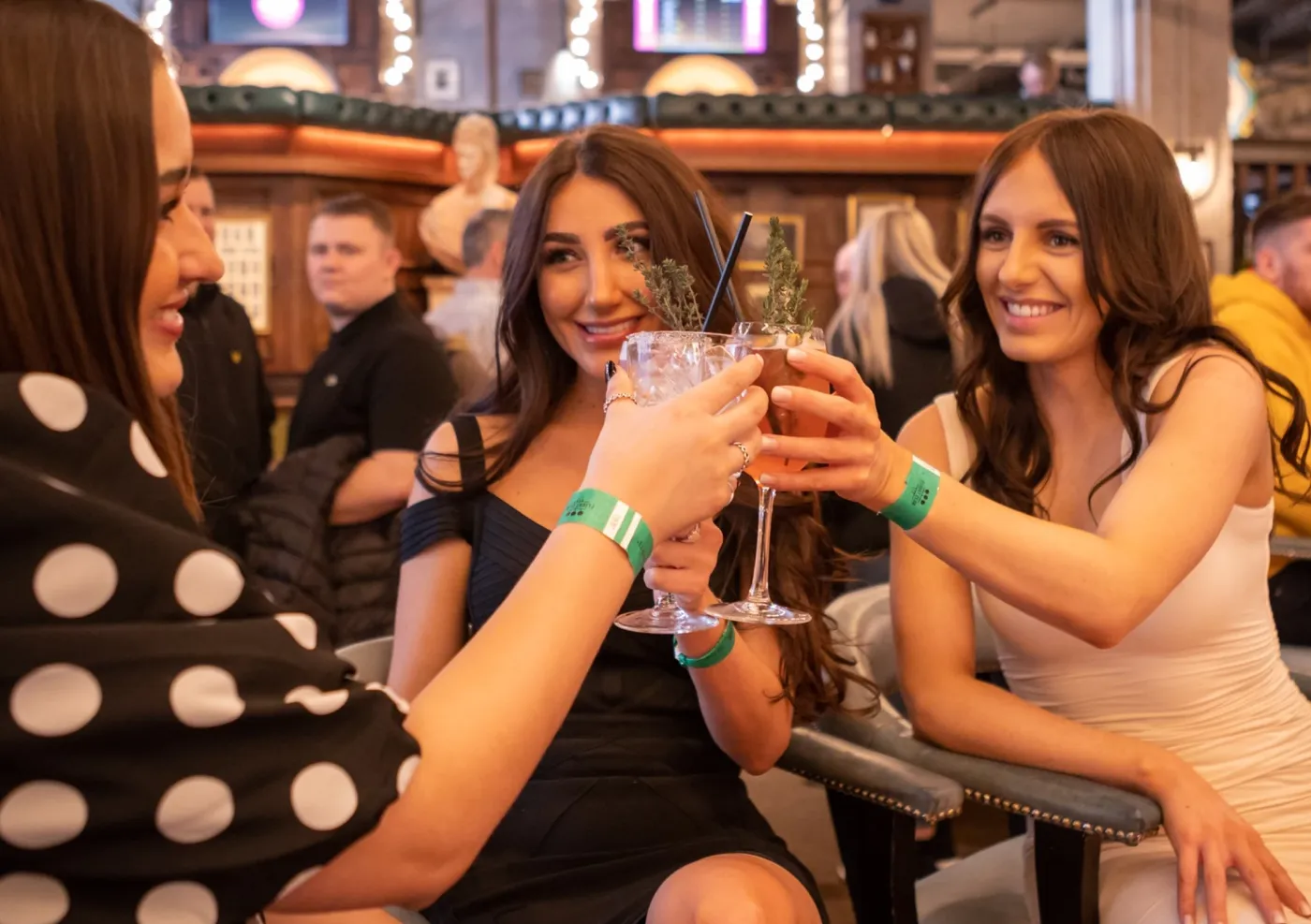 group of girls raising a glass at a flight club bar