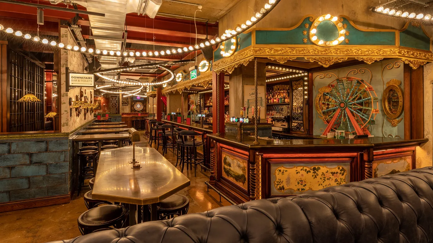 fairground bar and seating at flight club leeds