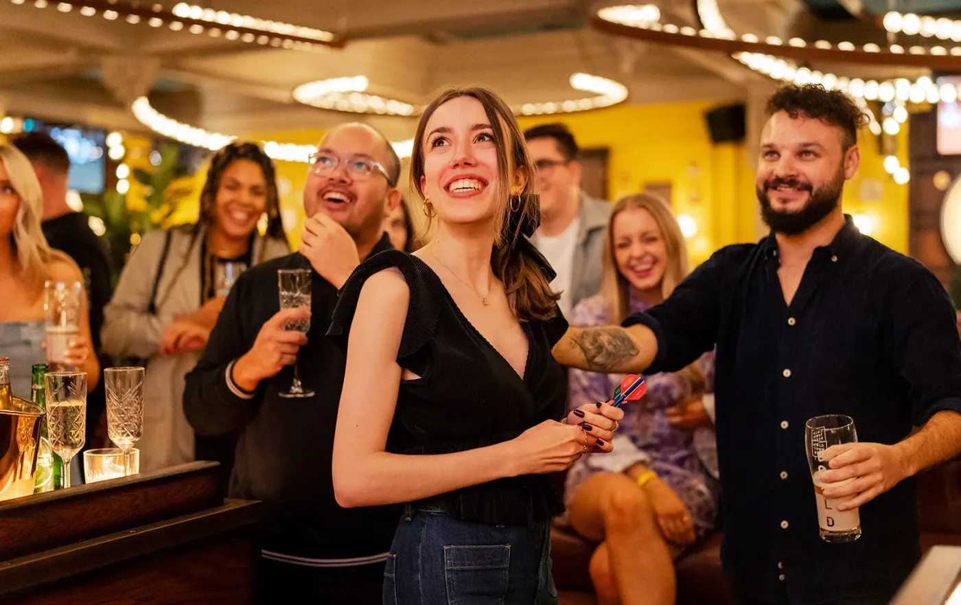 group playing social darts at a large event at flight club