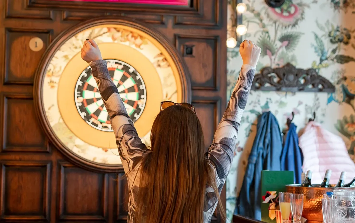 woman celebrating winning social darts at flight club
