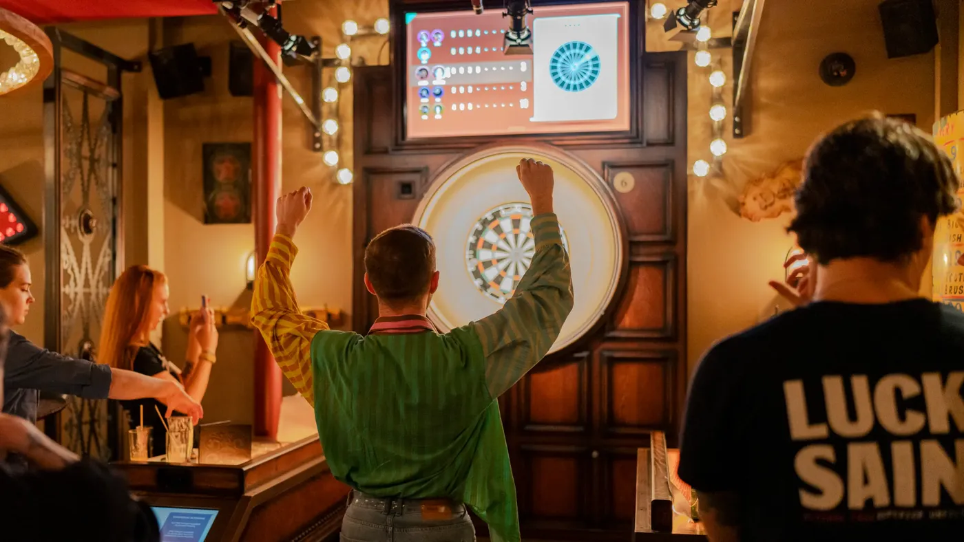 A group of people playing games at Flight Club