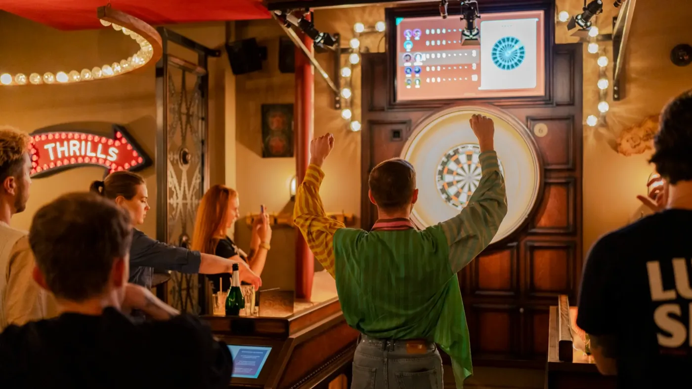 A group of people playing games at Flight Club