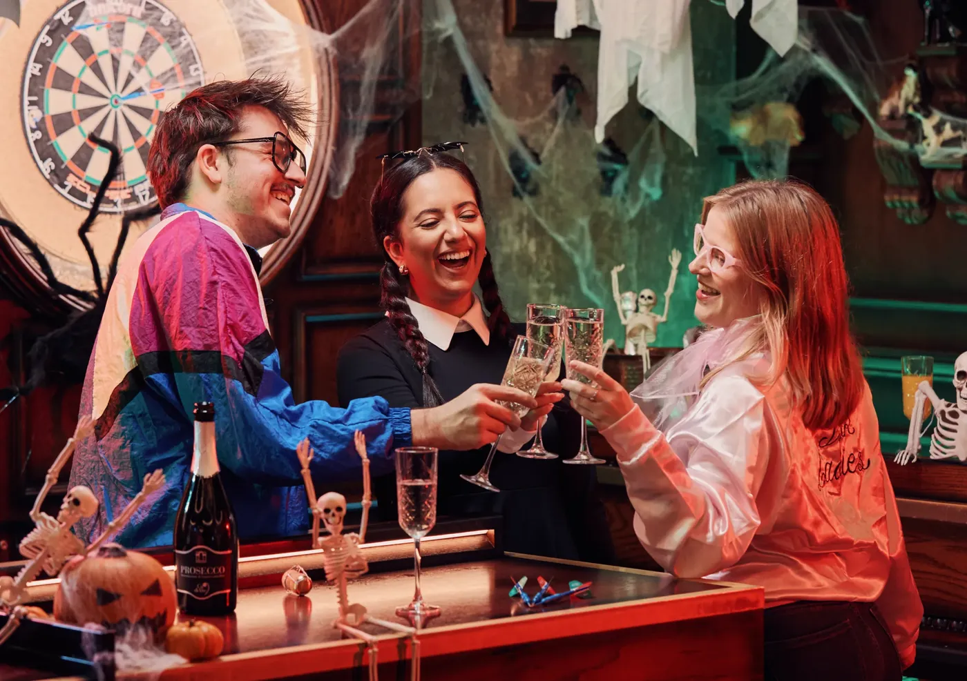 A group of people in Halloween costumes with drinks